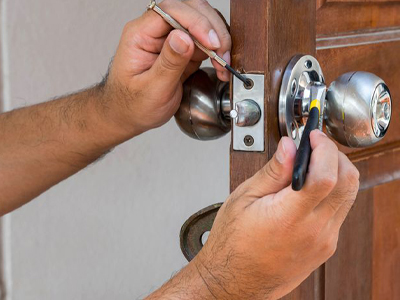 residential locksmith repairing a door lock