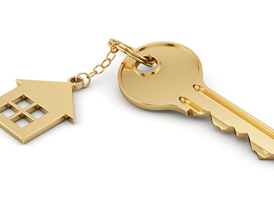 gold key with a house keychain